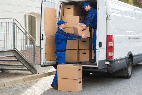 Local removal specialists loading items carefully into a van
