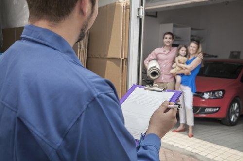 Local office movers handling equipment and boxes in South London